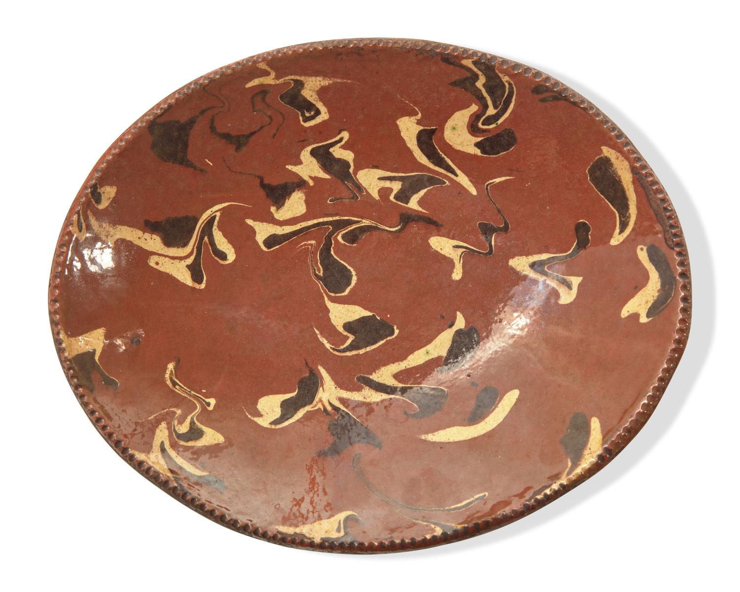 An Oval Redware Bread Dish with Marbleized Slip, New England, 19th Century
