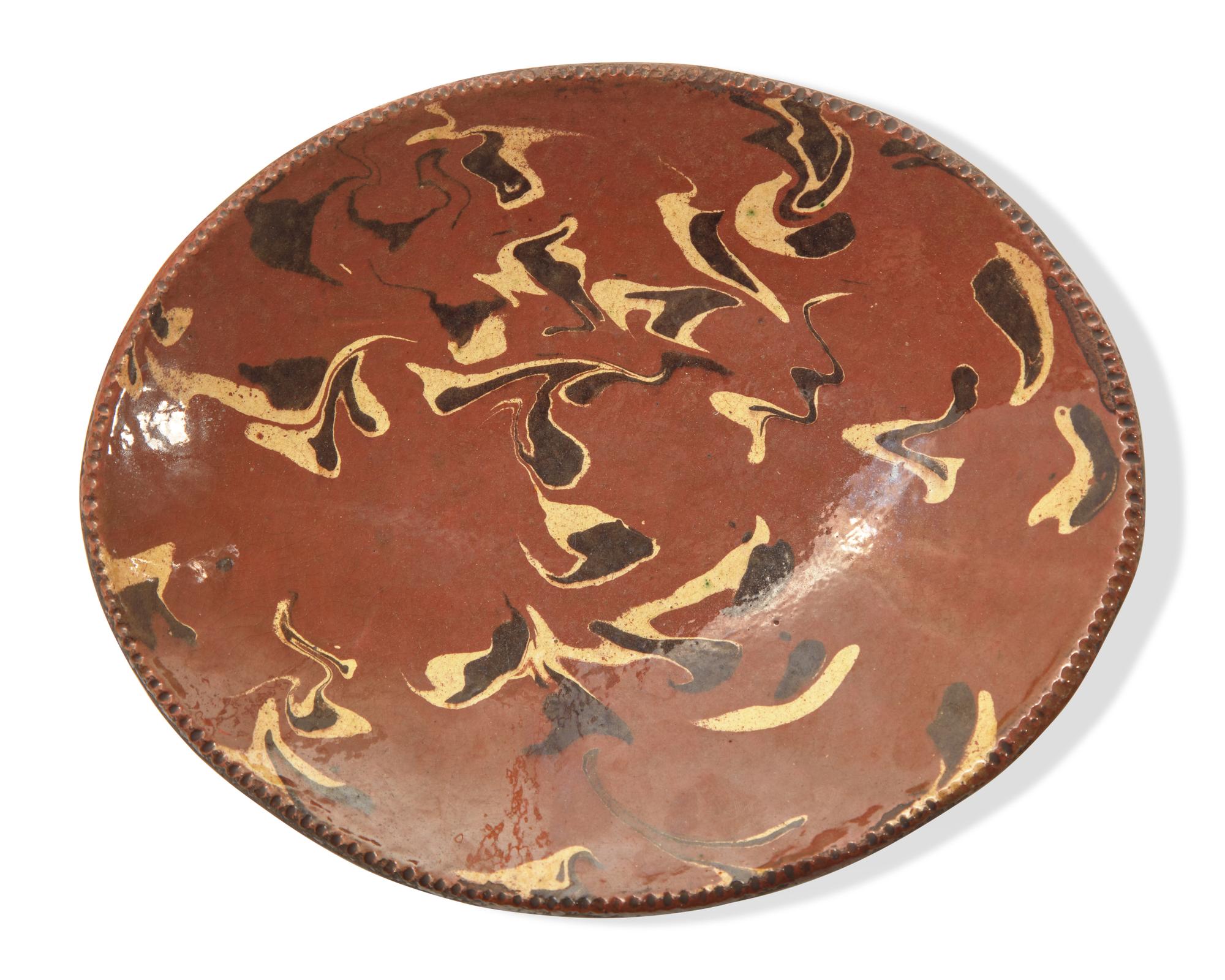 An Oval Redware Bread Dish with Marbleized Slip, New England, 19th Century