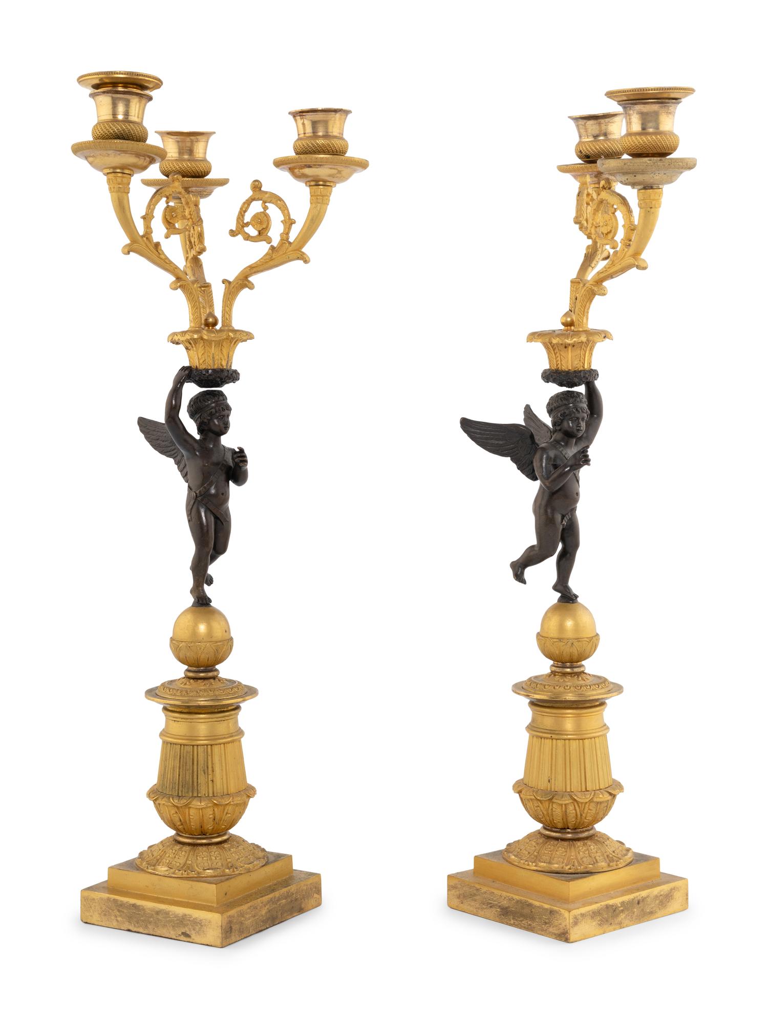 A Pair of Empire Style Gilt and Patinated Bronze Figural Candelabra
