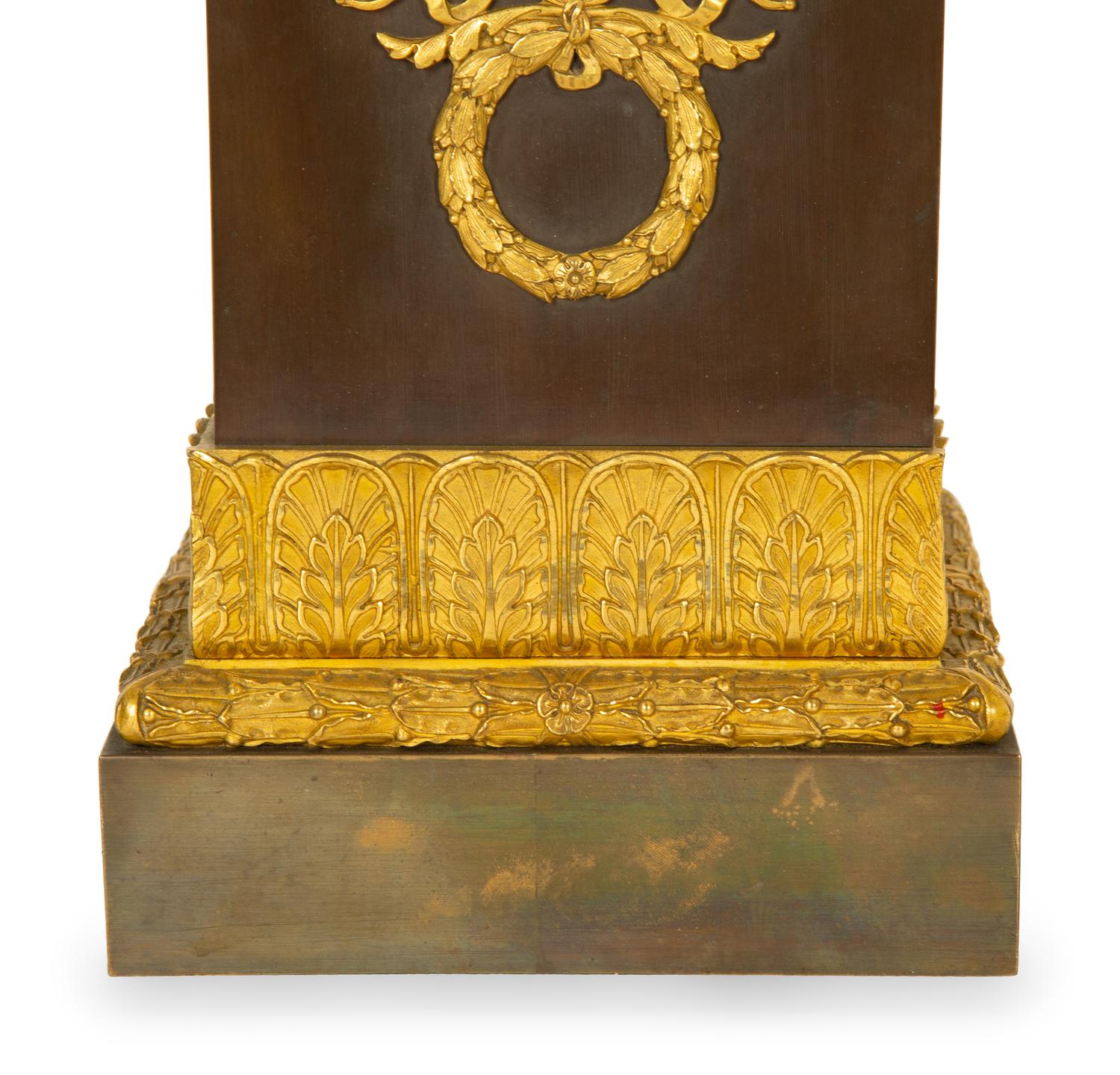 A Gilt Bronze Eagle Sculpture on an Empire Style Gilt and Patinated Bronze Base