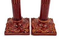 A Pair of English Bermantofts Red-Glazed Faïence Column-Form Candlesticks