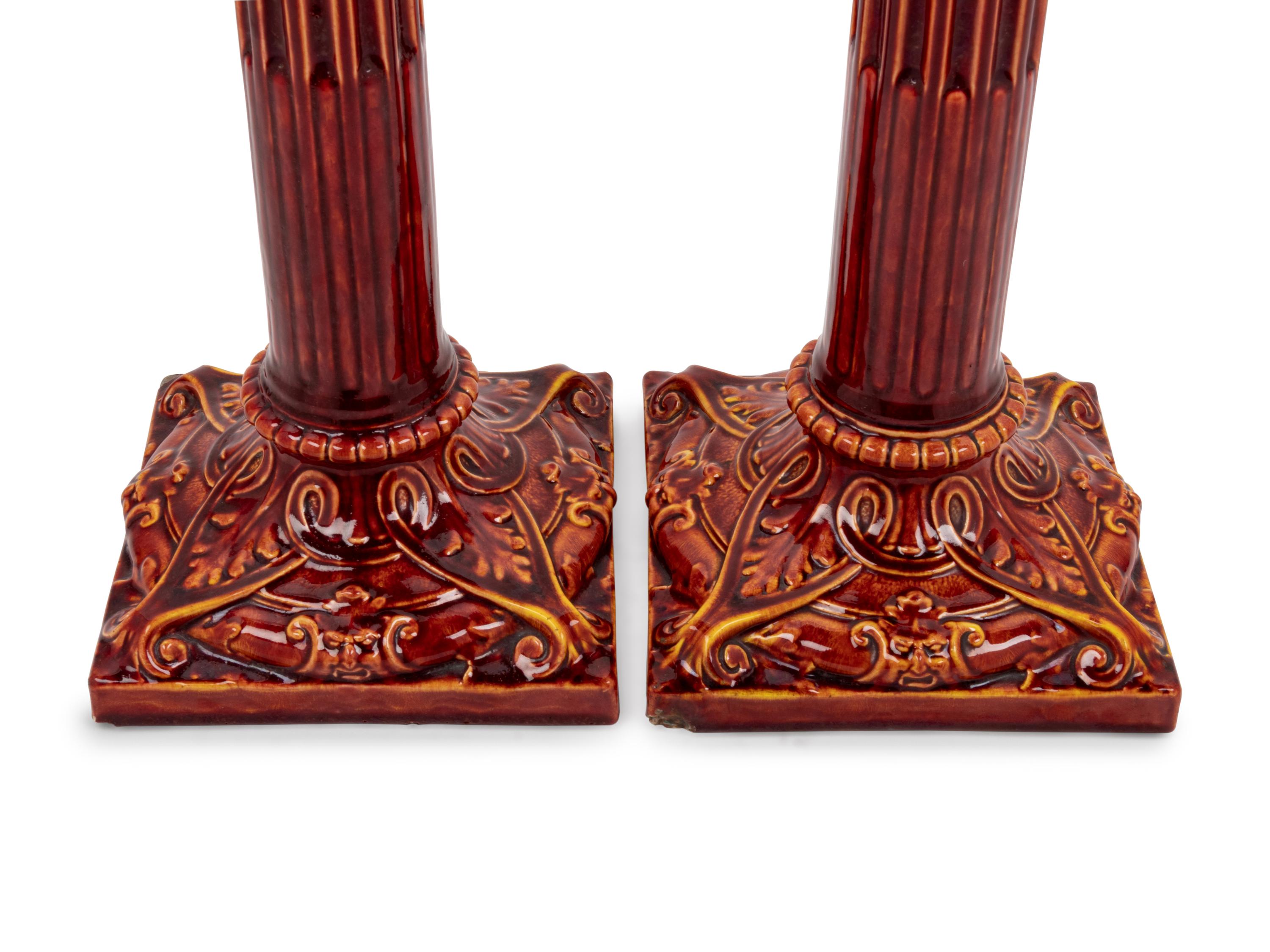 A Pair of English Bermantofts Red-Glazed Faïence Column-Form Candlesticks