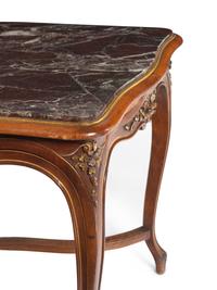 An Italian Louis XV Style Carved Walnut Marble-Inset Serpentine-Top Center Table