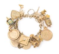 A Vintage Yellow Gold Charm Bracelet with Twenty-Four Attached Charms, 41.20 dwts.
