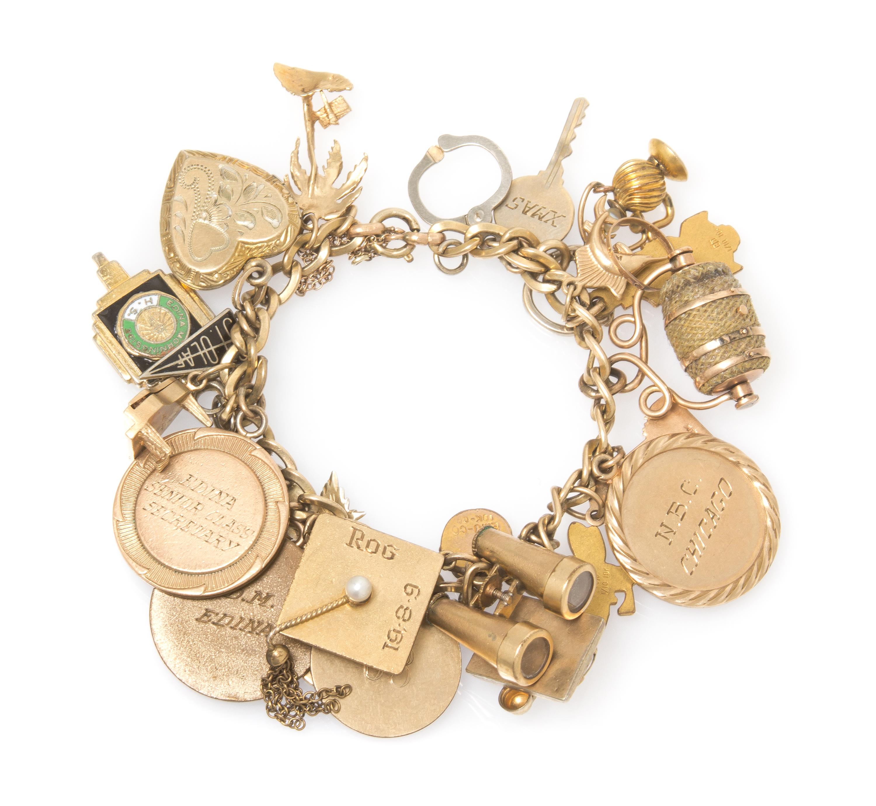 A Vintage Yellow Gold Charm Bracelet with Twenty-Four Attached Charms, 41.20 dwts.