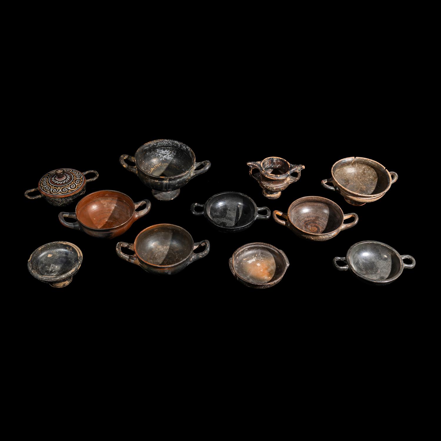 Eleven Greek Black-Glazed Vessels and Lids