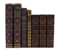 (BINDINGS) A group of 7 leather-bound volumes.