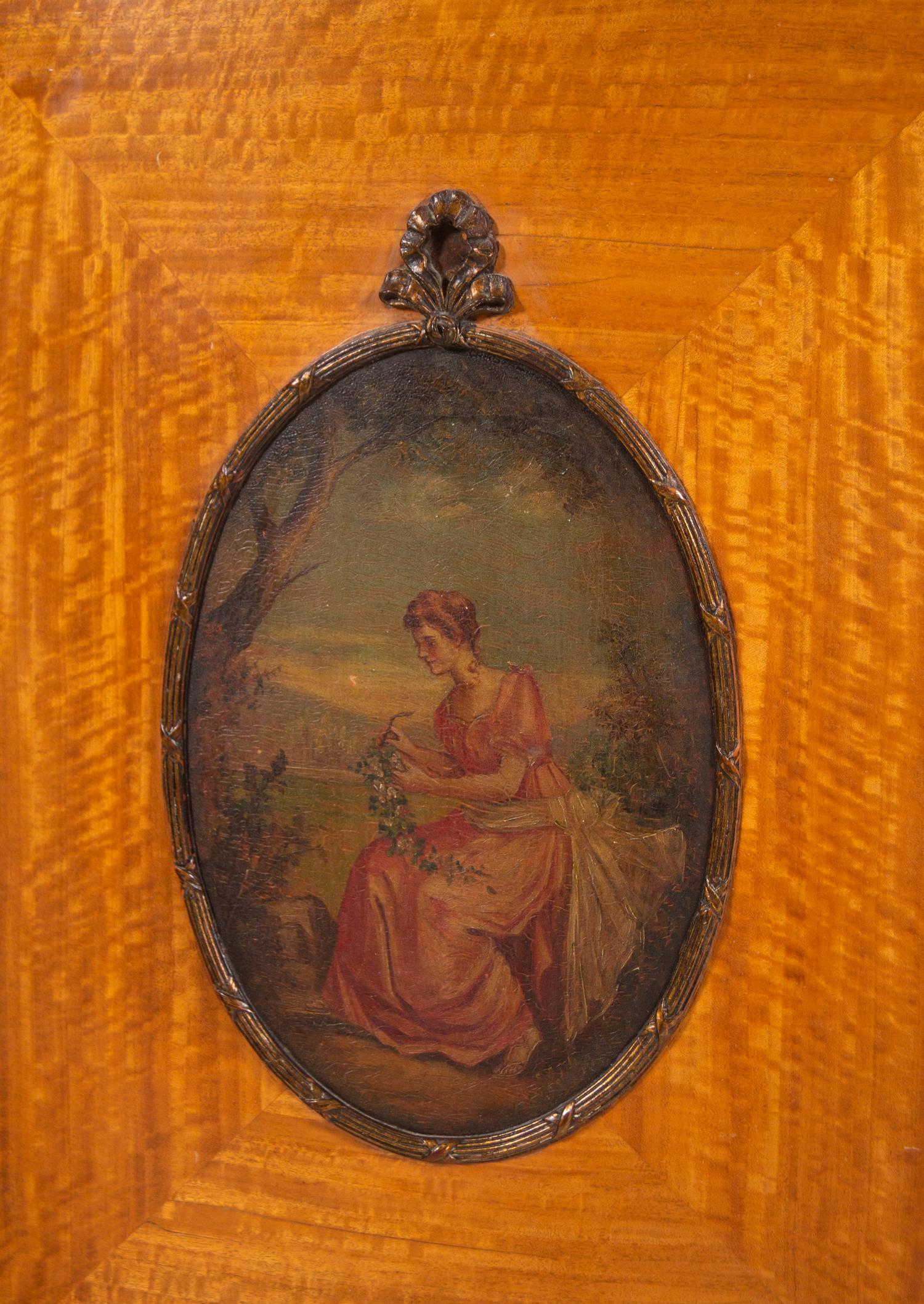 An Edwardian Painted Satinwood Bowfront Cabinet