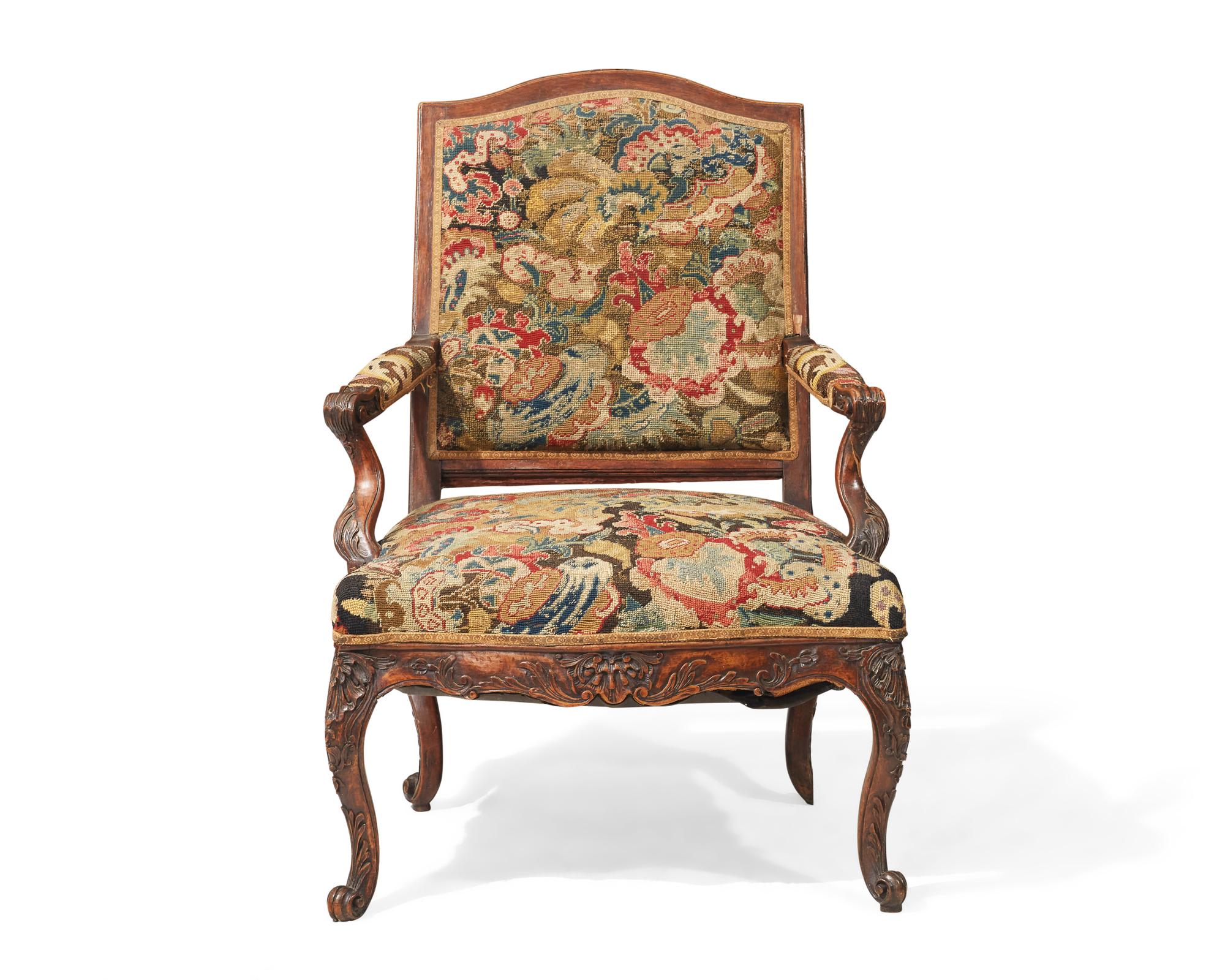 A French Régence fauteuil à la reine with petit point upholstery, 18th century