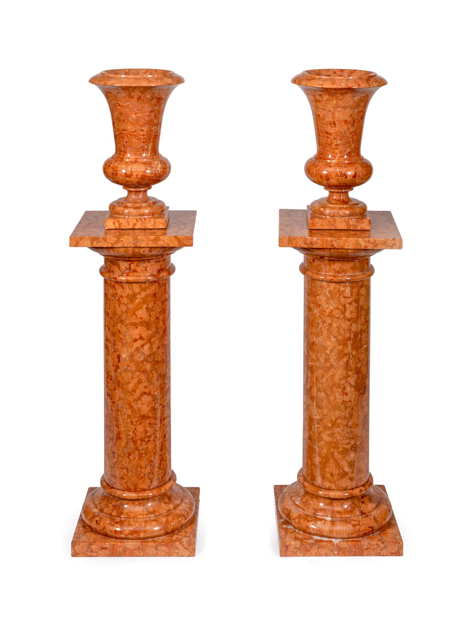 A Pair of Red Marble Urns on Pedestals — 20TH CENTURY