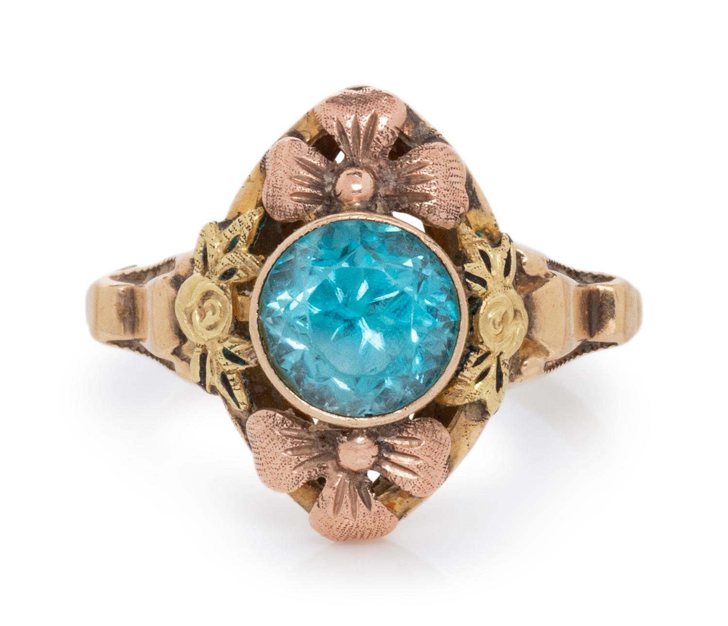 A 10 Karat Bicolor Gold and Blue Zircon Floral Motif Ring,