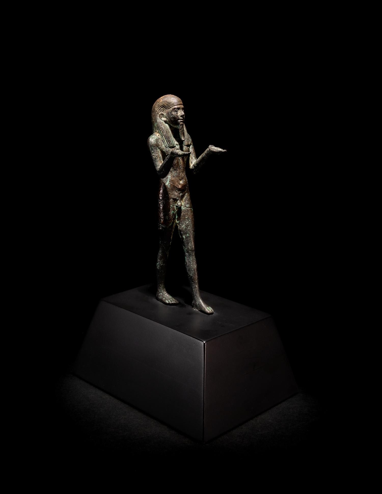 An Egyptian Bronze King or Deity as a Nude Offering-Bearer