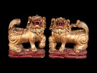 A Pair of Chinese Gilt and Red Lacquered Wood Figures of Fu Lions