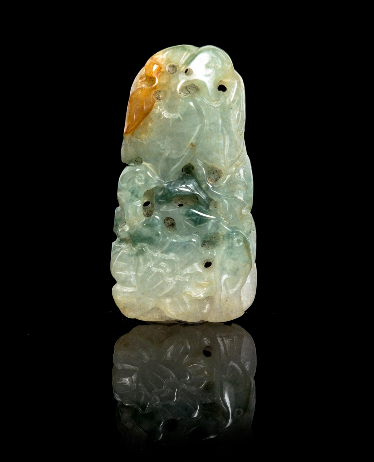 A Carved Jadeite Pendant Height 2 inches.