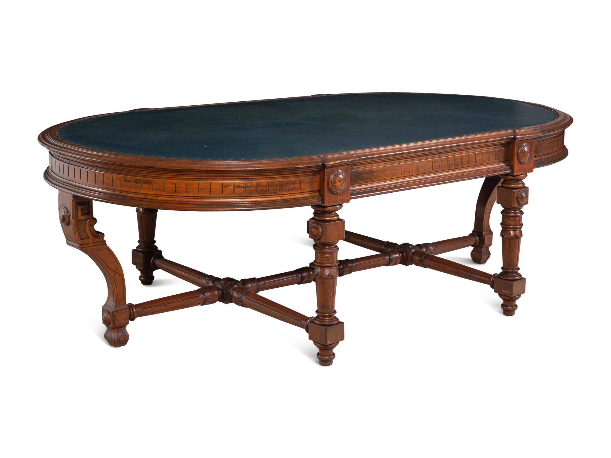 An Aesthetic Movement Leather Inset Carved Walnut Board Table