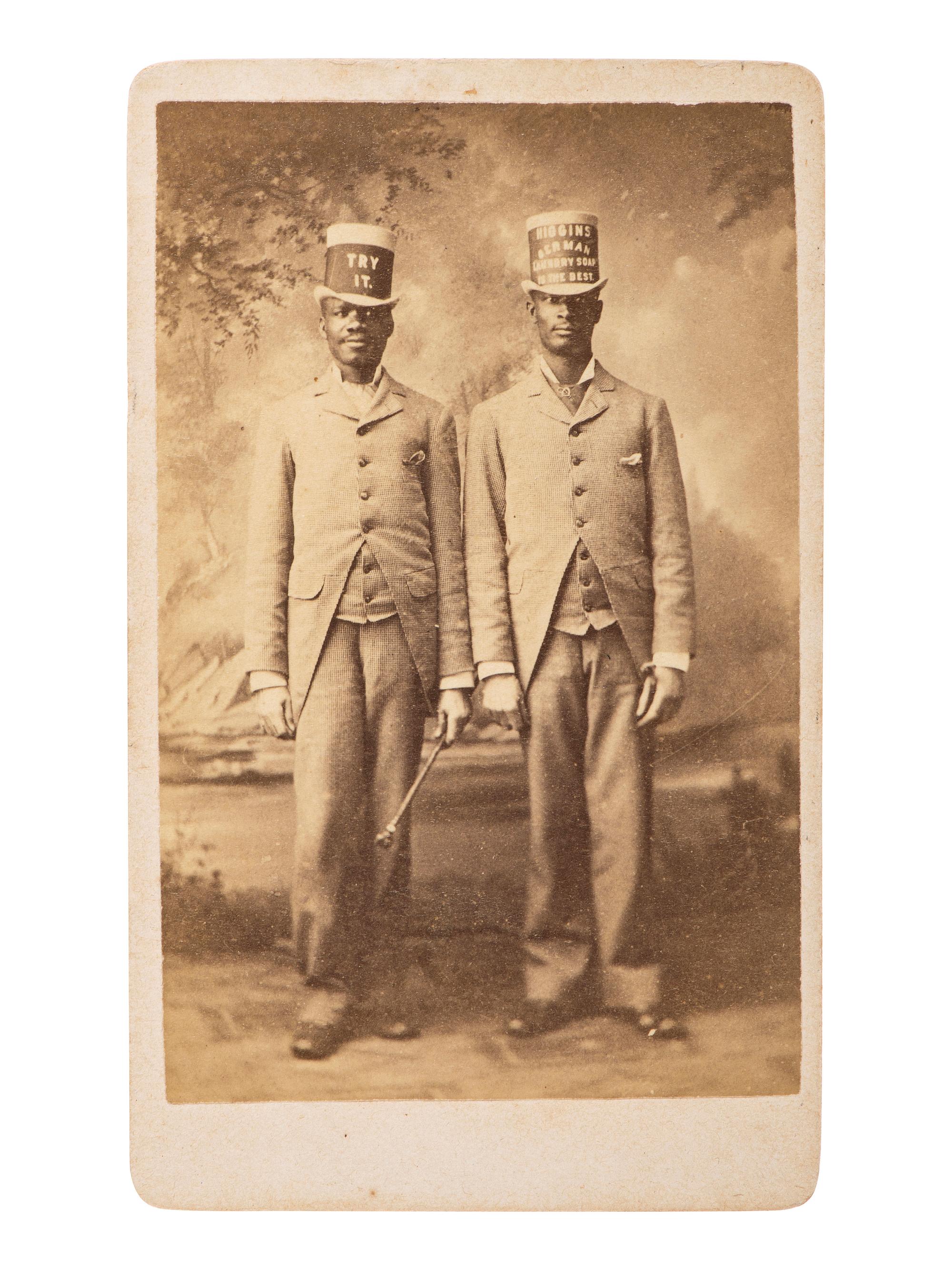[AFRICAN AMERICANA - EARLY PHOTOGRAPHY]. Occupational CDV featuring two African American men advertising Higgins Berman Laundry Soap. Brooklyn, NY: B. Block.