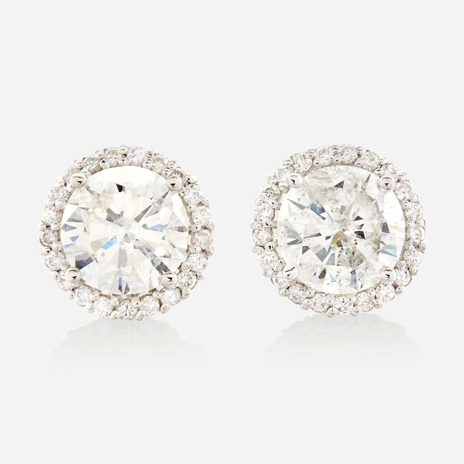 A pair of diamond and gold earrings