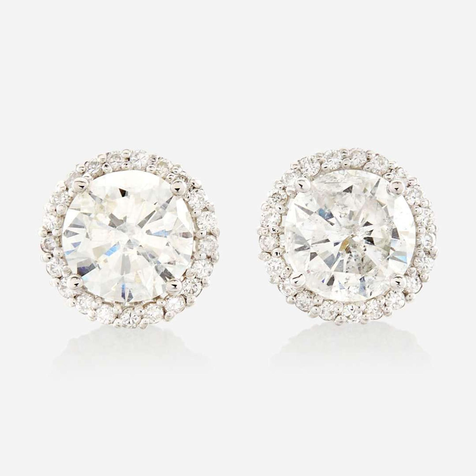 A pair of diamond and gold earrings