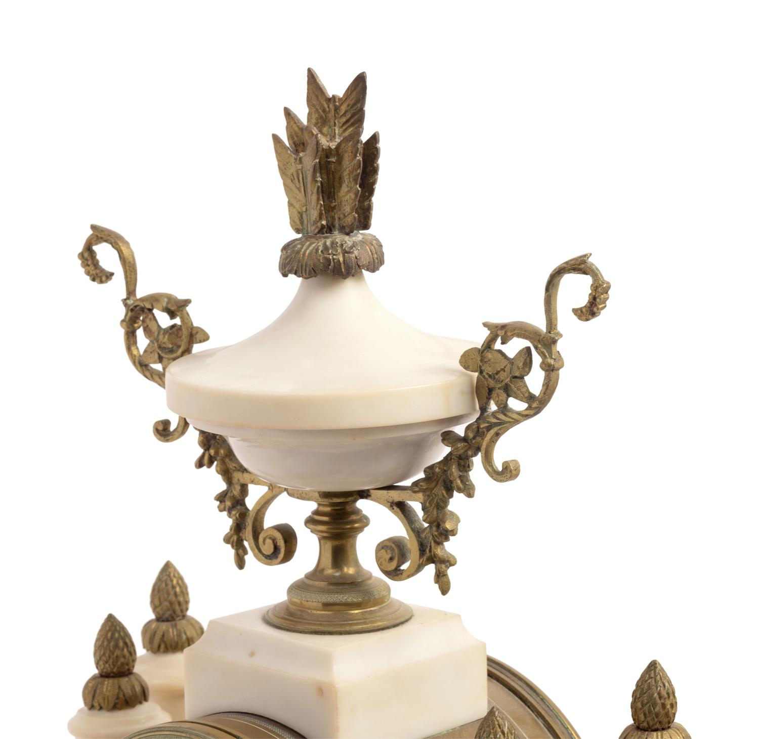 A French Gilt Metal Mounted Marble Three-Piece Clock Garniture