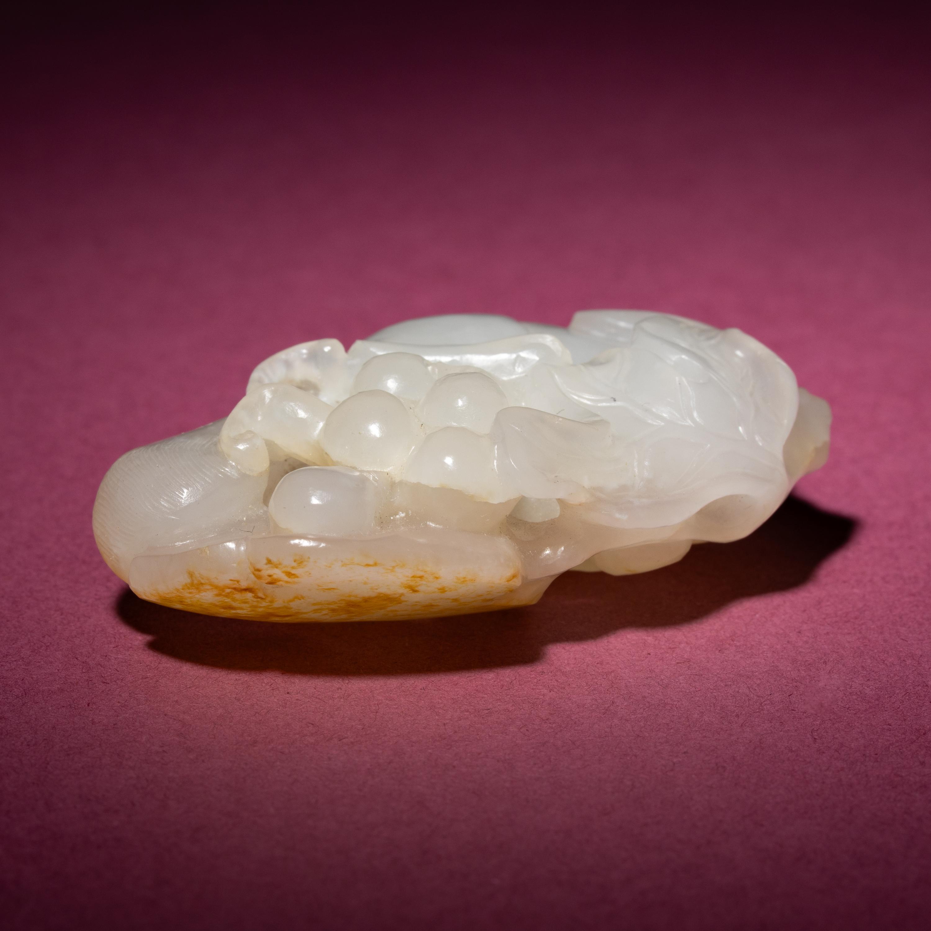 A Chinese Russet and White Jade 'Squirrel and Grape' Carving, 18th/19th Century — 清中期 白玉留皮松鼠葡萄