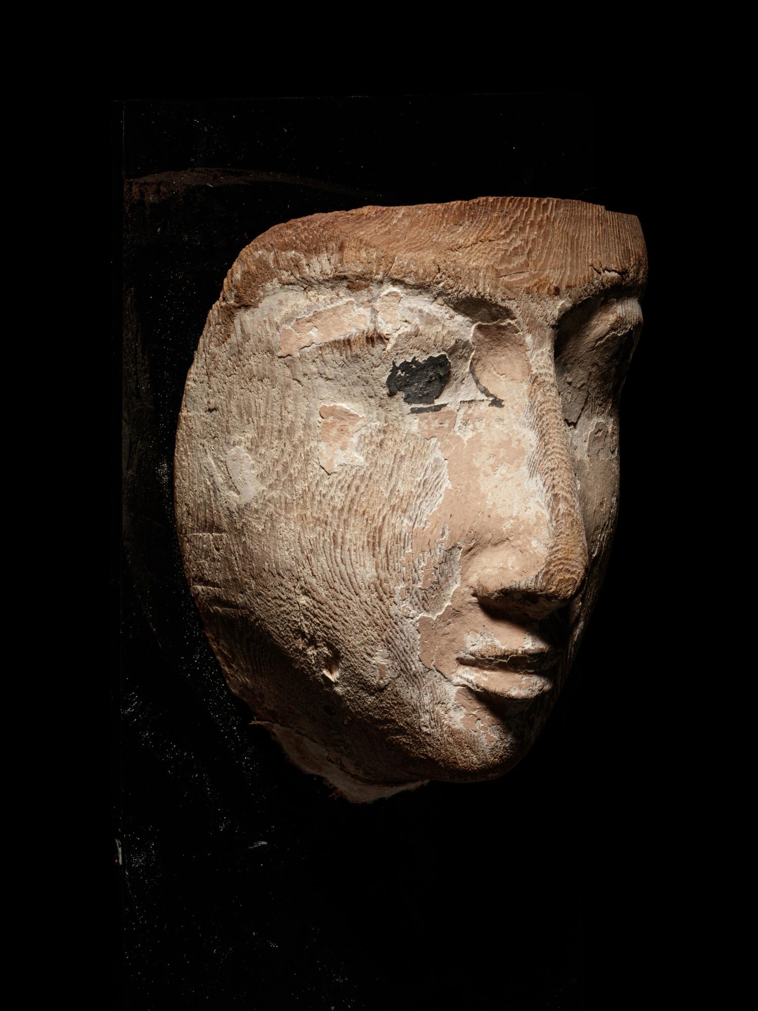 An Egyptian Wood Mummy Mask of a Woman