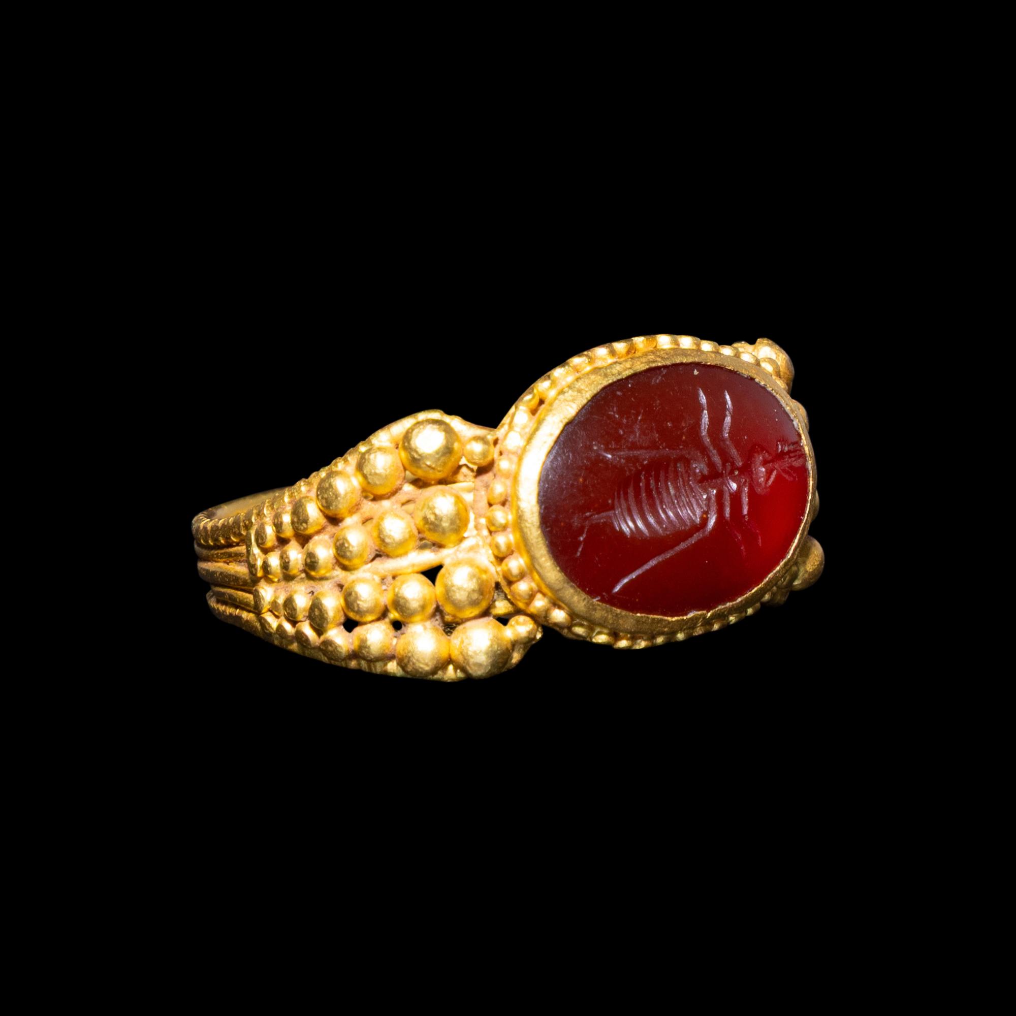 A Late Roman Gold and Carnelian Ring with an Ant Carrying an Ear of Wheat