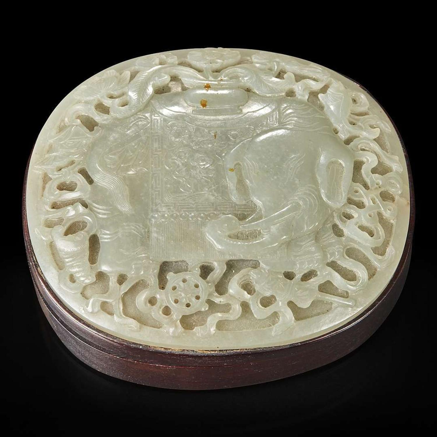 A Chinese carved celadon jade "Elephant" plaque mounted as a box 木盒嵌太平有象浮雕玉板