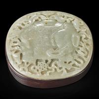 A Chinese carved celadon jade "Elephant" plaque mounted as a box 木盒嵌太平有象浮雕玉板