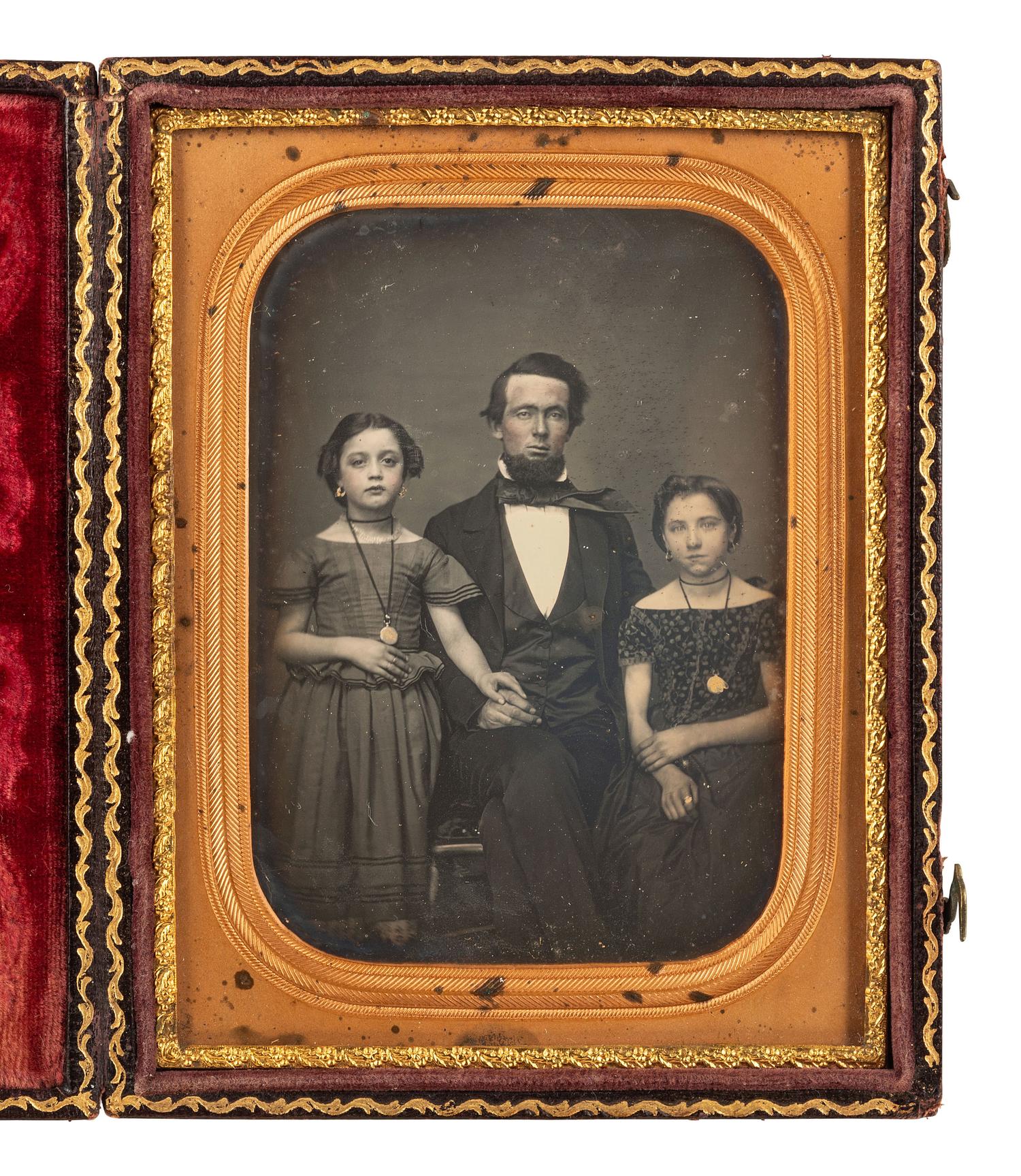 [EARLY PHOT.]. 2 daguerreotypes of attractive subjects, incl. father with children & young woman.