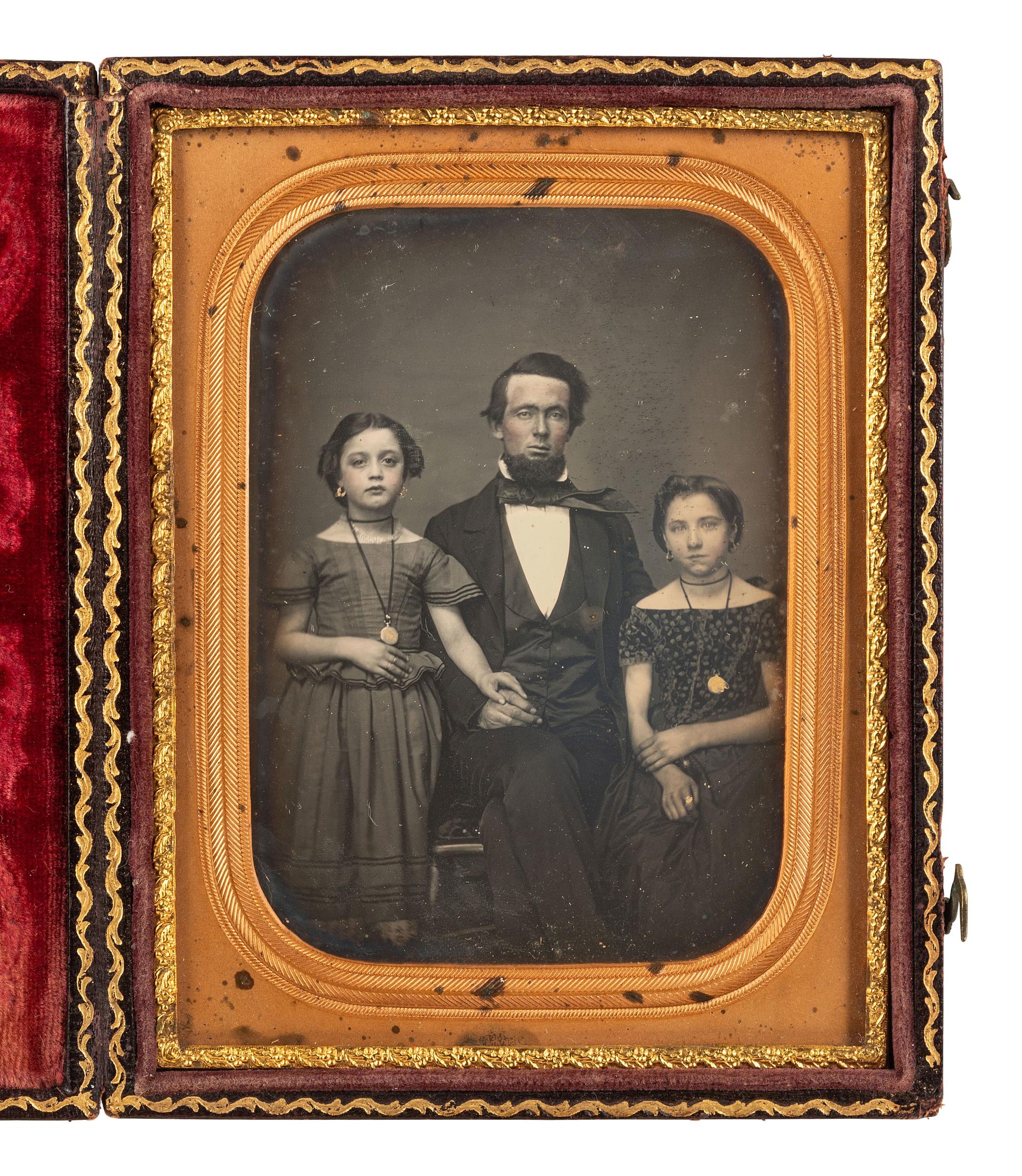 [EARLY PHOT.]. 2 daguerreotypes of attractive subjects, incl. father with children & young woman.