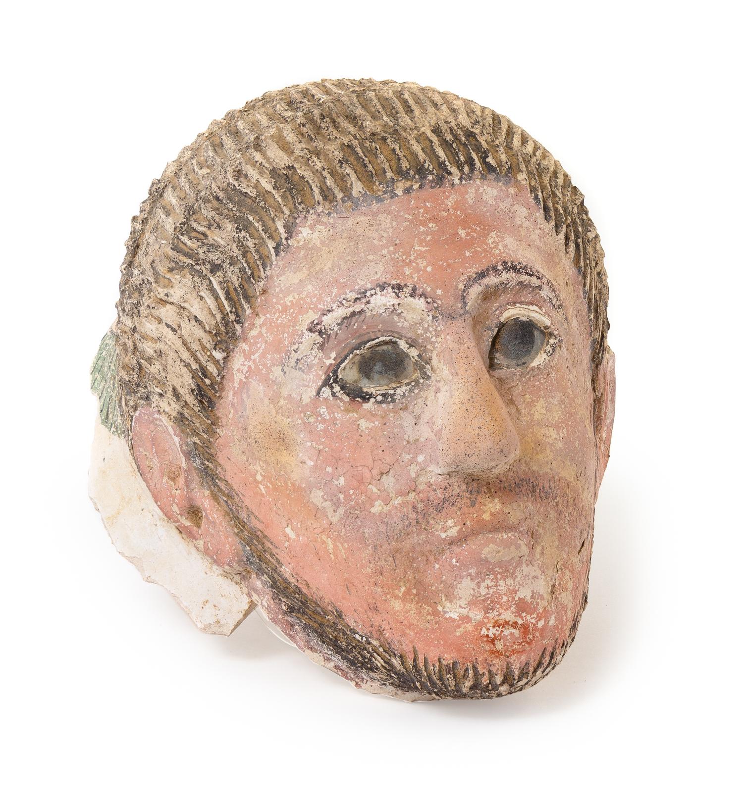 A Romano-Egyptian Plaster Mummy Mask Height 9 1/2 inches. — CIRCA 2ND CENTURY C.E.
