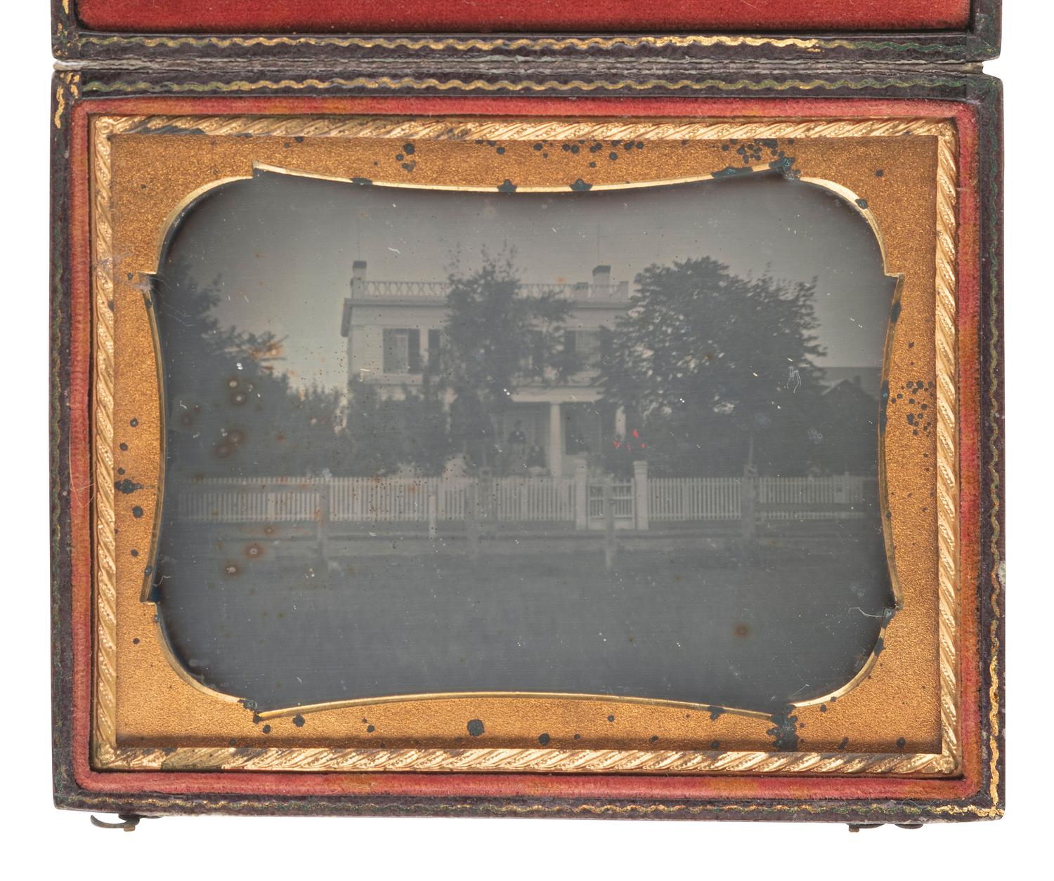[EARLY PHOTOGRAPHY]. Quarter plate daguerreotype of a stately home with picket fence and trees.