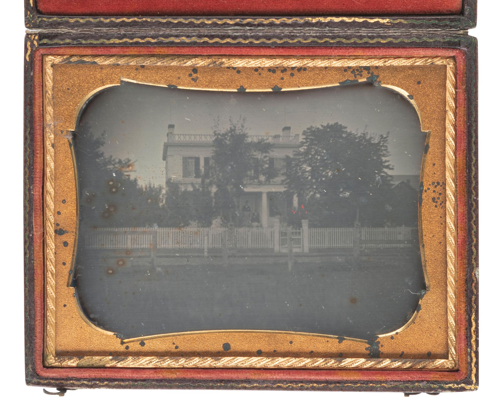 [EARLY PHOTOGRAPHY]. Quarter plate daguerreotype of a stately home with picket fence and trees.
