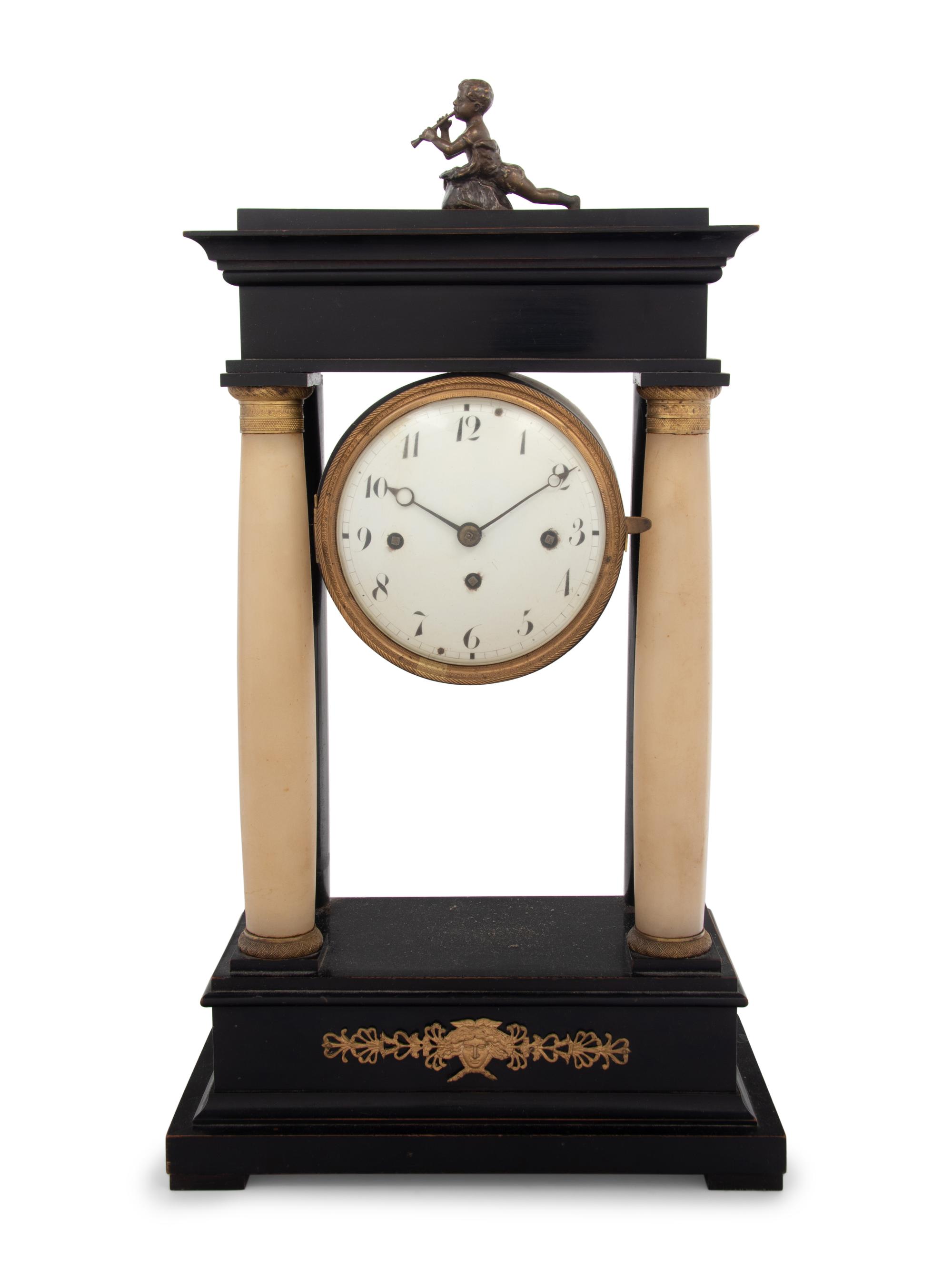 An Empire Style Gilt Metal and Alabaster Mounted Ebonized Clock