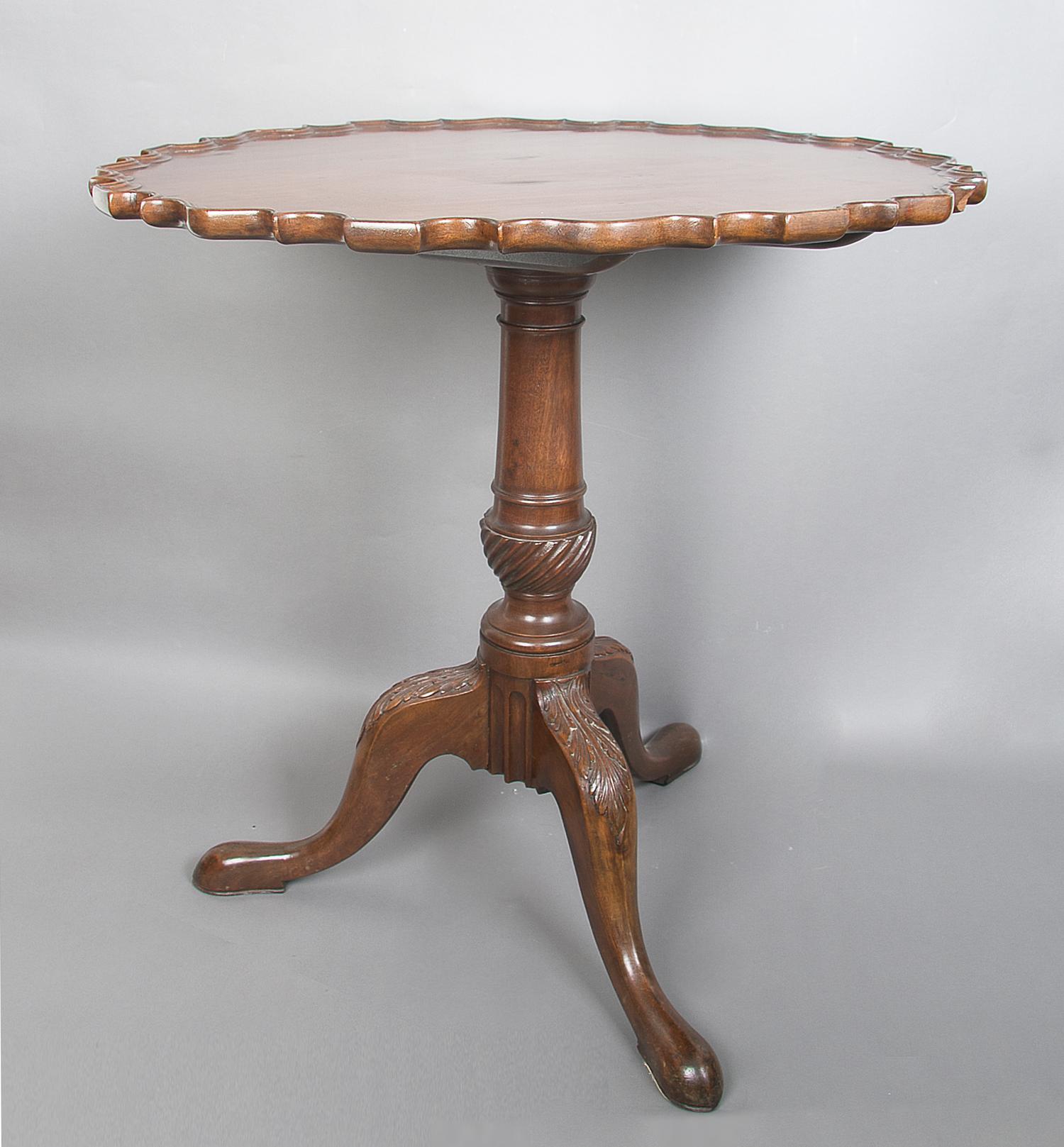 A Chippendale Style Mahogany Tilt-Top Tea Table, Height 27 1/2 x diameter 27 1/4 inches.