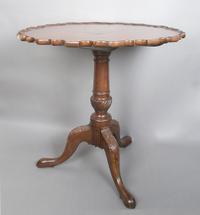 A Chippendale Style Mahogany Tilt-Top Tea Table, Height 27 1/2 x diameter 27 1/4 inches.