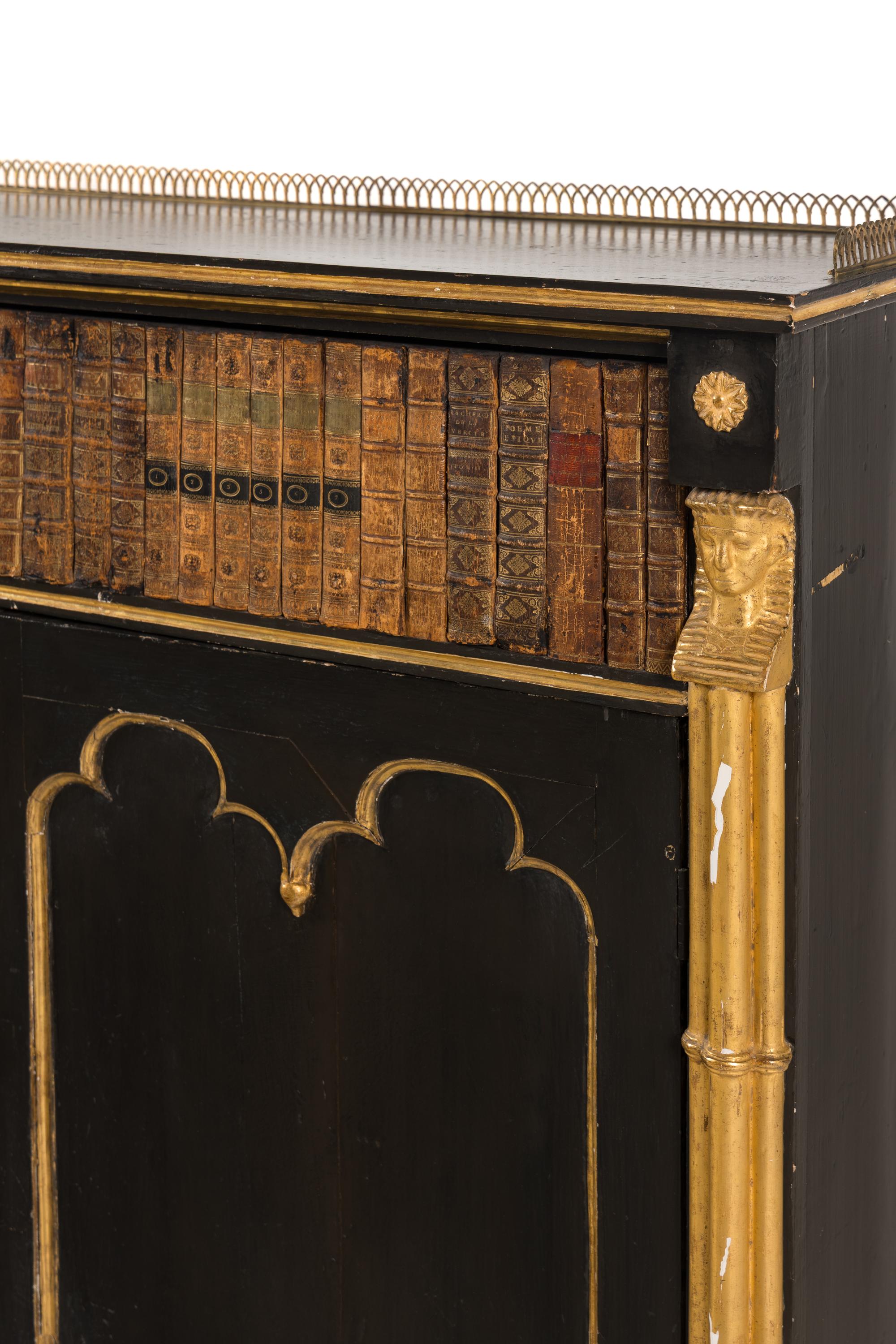 A Regency Black-Painted, Parcel-Gilt and Faux Book Front Cabinet