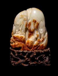 A Chinese Celadon and Russet Jade 'Landscape' Boulder