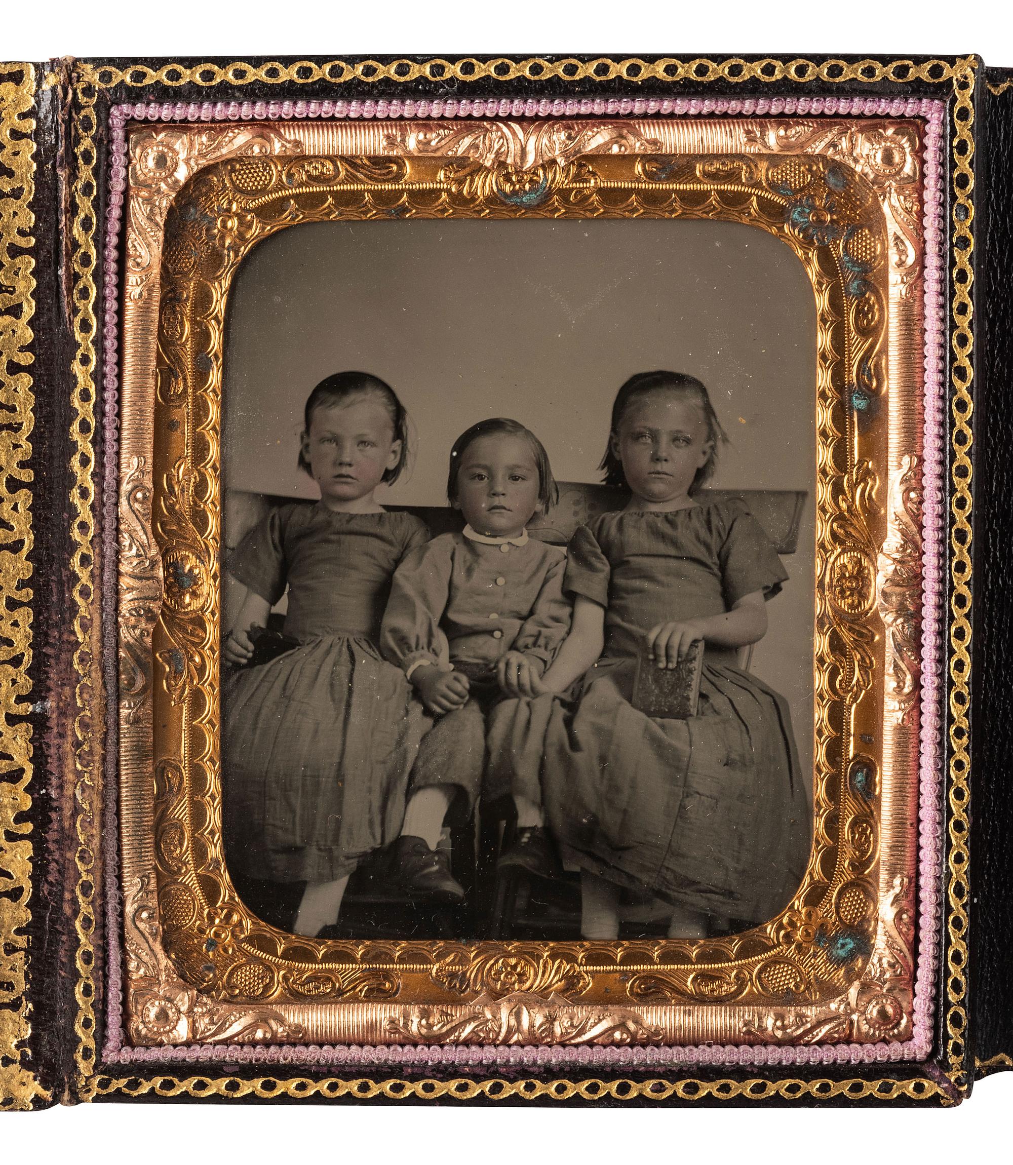 [EARLY PHOTOGRAPHY]. A group of 4 cased images featuring subjects holding cased images.