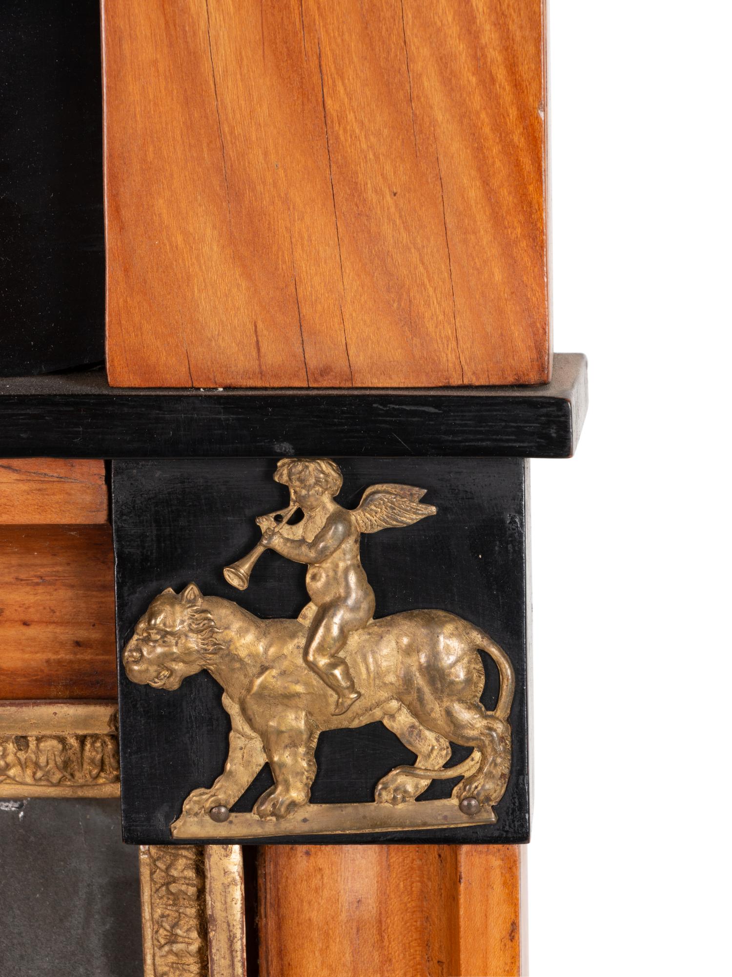 A Biedermeier Parcel Ebonized and Gilt Metal Mounted Mirror