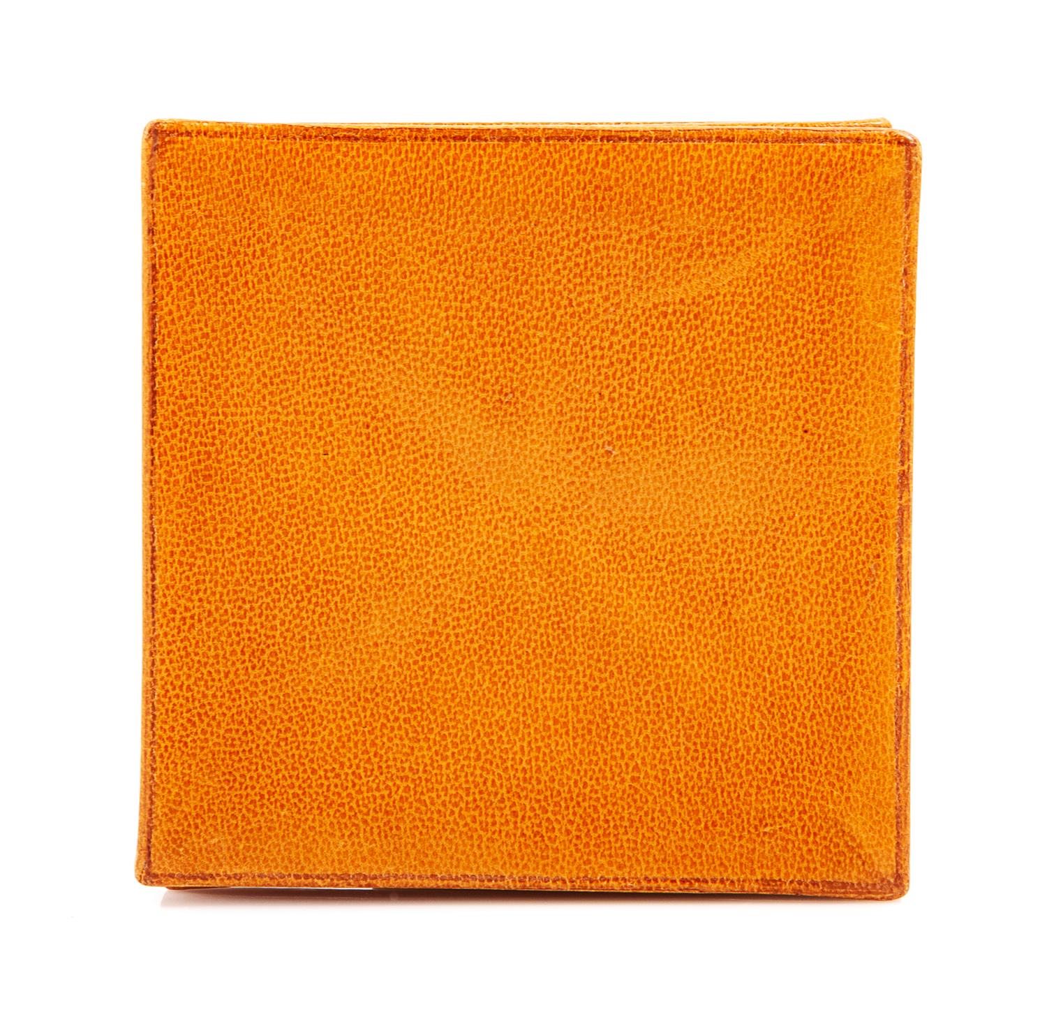 An Hermès Orange Leather Zulu Coin Purse, 3.25" x 3.25".