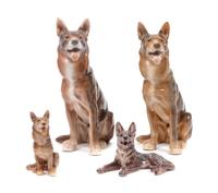A Group of Four Porcelain German Shepherds Height of tallest 8 3/4 inches.
