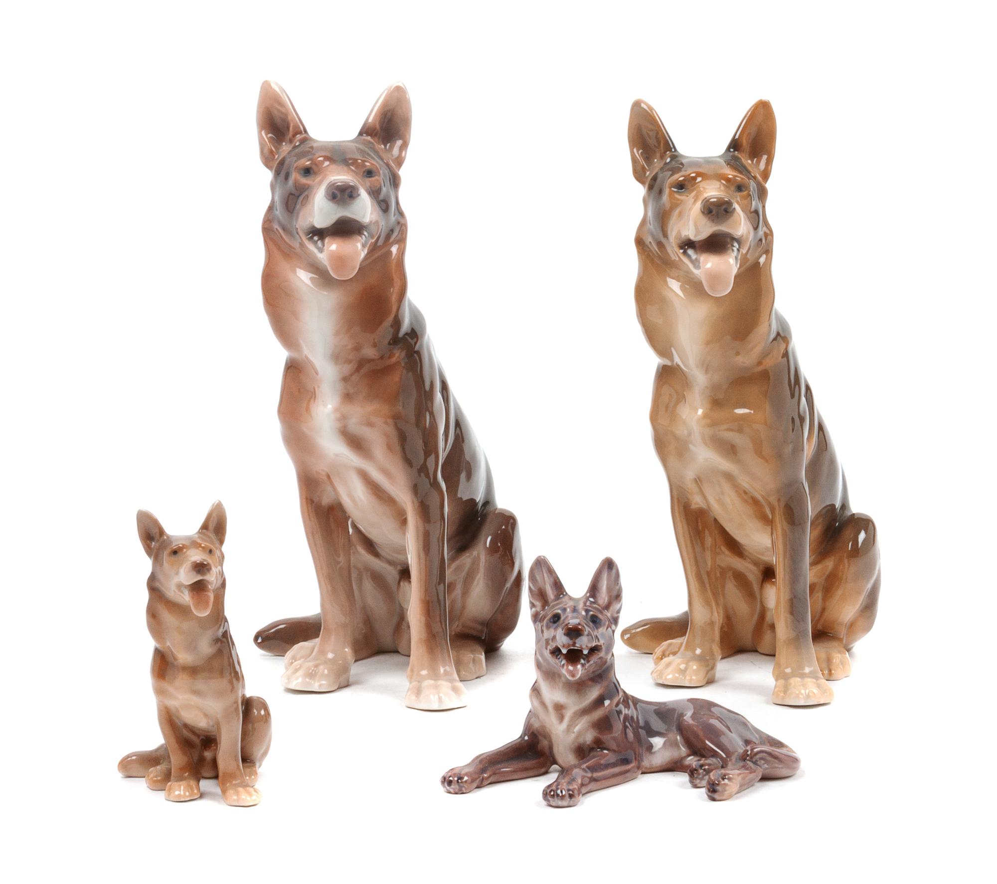 A Group of Four Porcelain German Shepherds Height of tallest 8 3/4 inches.