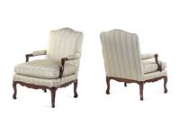 A Pair of Louis XV Style Carved Walnut Fauteuils