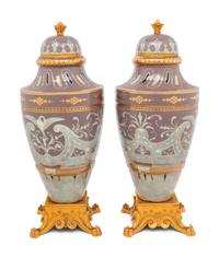 A Pair of Continental Pâte-sur-Pâte Porcelain and Gilt-Bronze Mounted Covered Urns