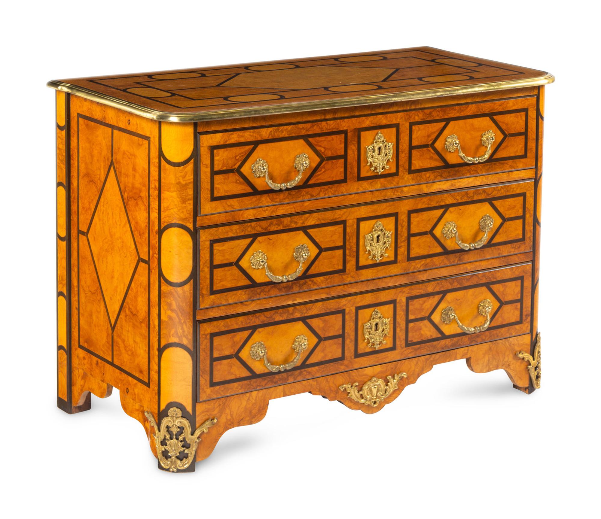 A Régence Style Gilt Metal Mounted Burl Walnut Chest of Drawers