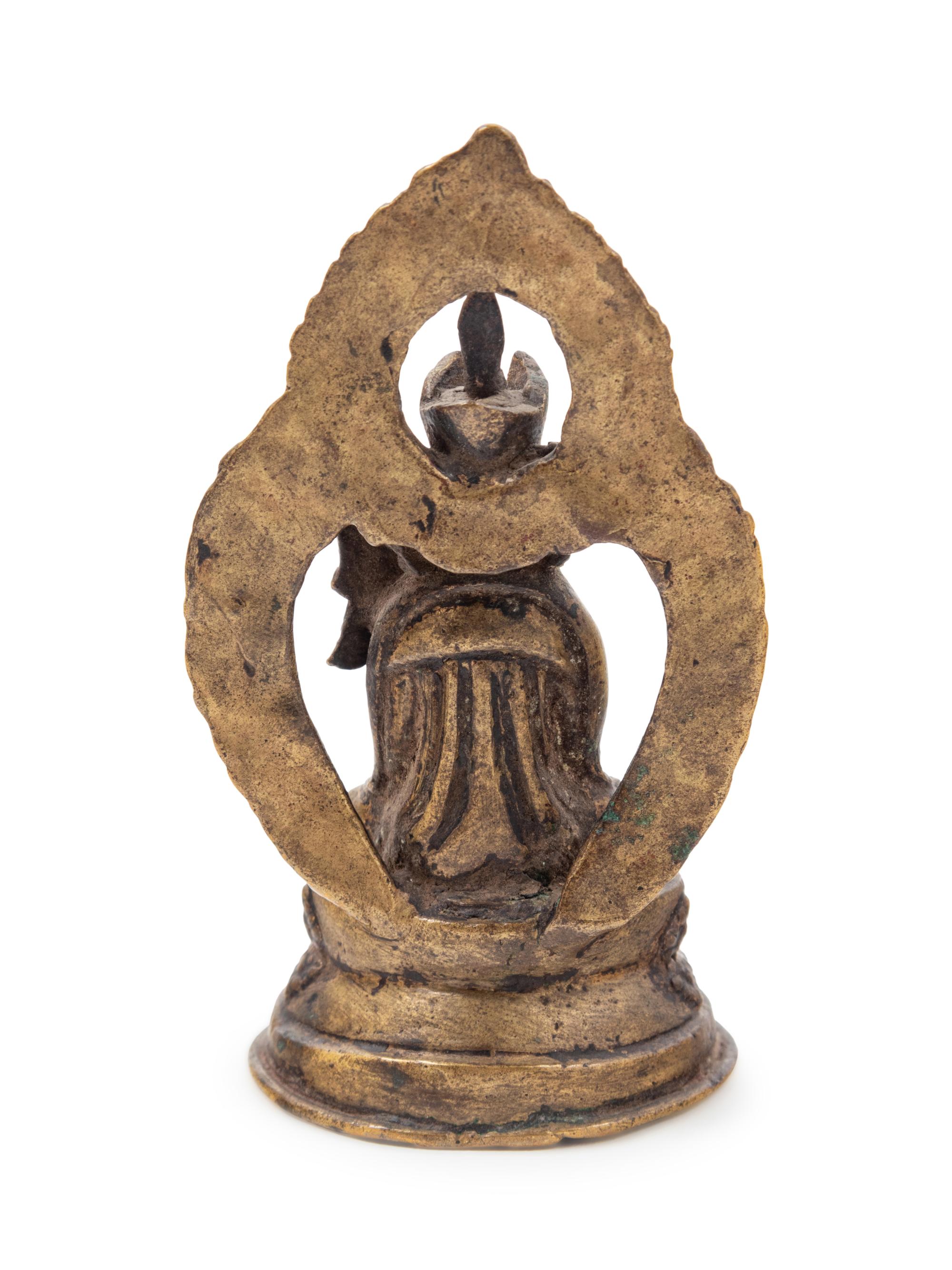 A Small Tibetan Gilt Bronze Figure of a Lama