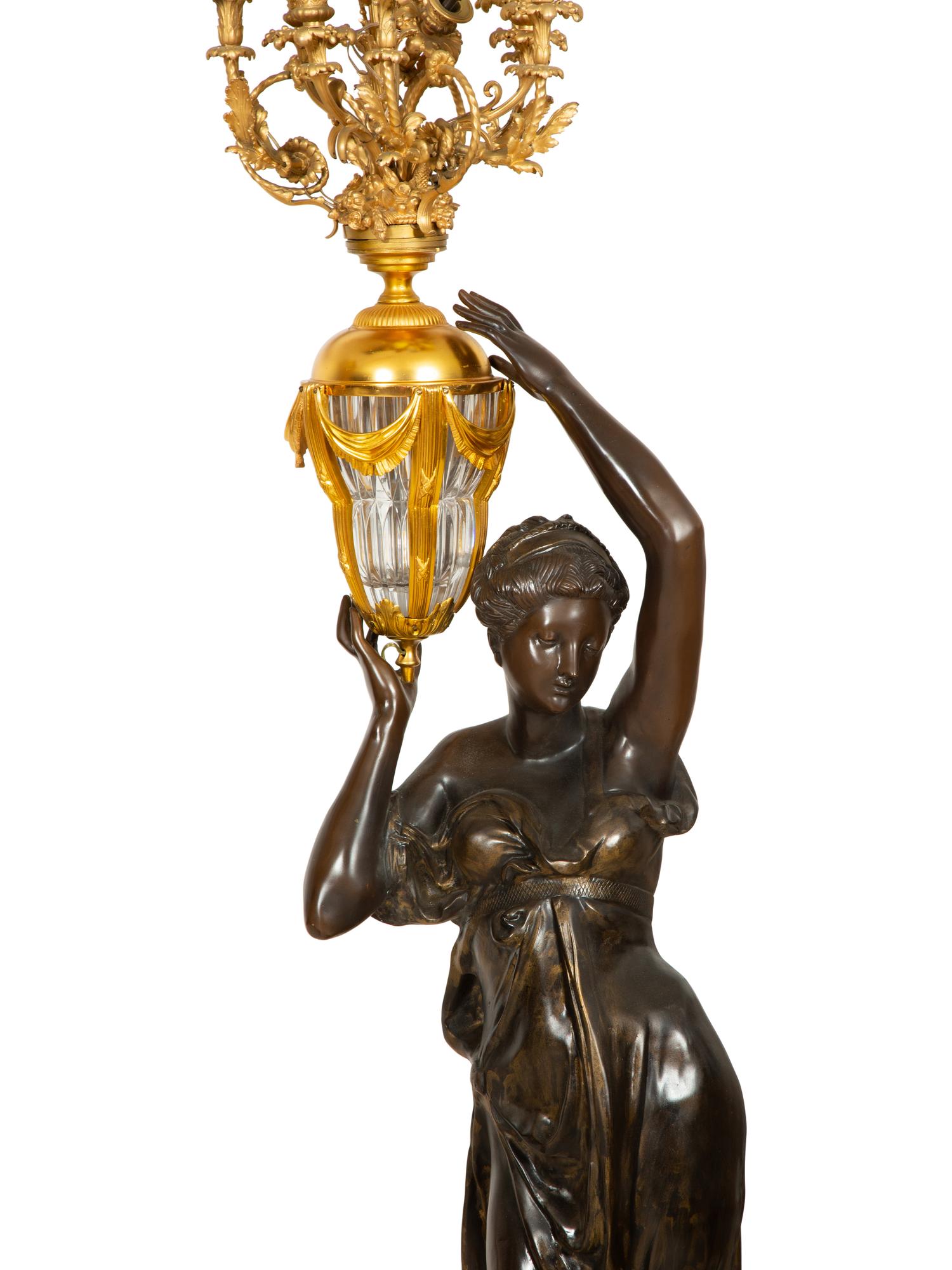 A Pair of French Gilt and Patinated Bronze Figural Nine-Light Torchères