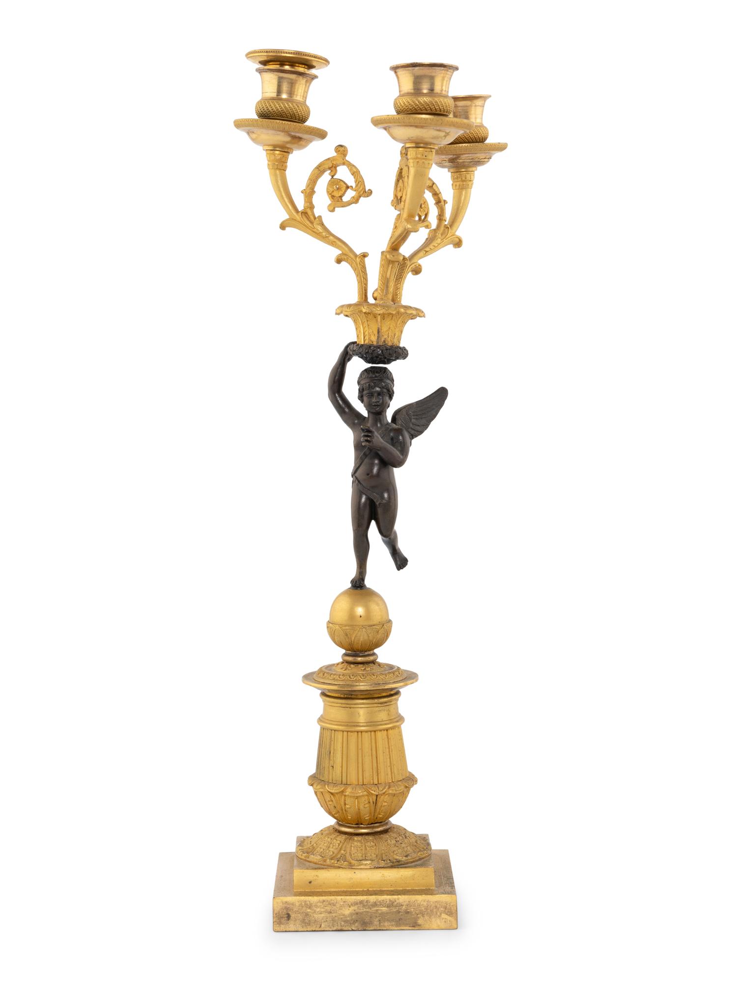 A Pair of Empire Style Gilt and Patinated Bronze Figural Candelabra