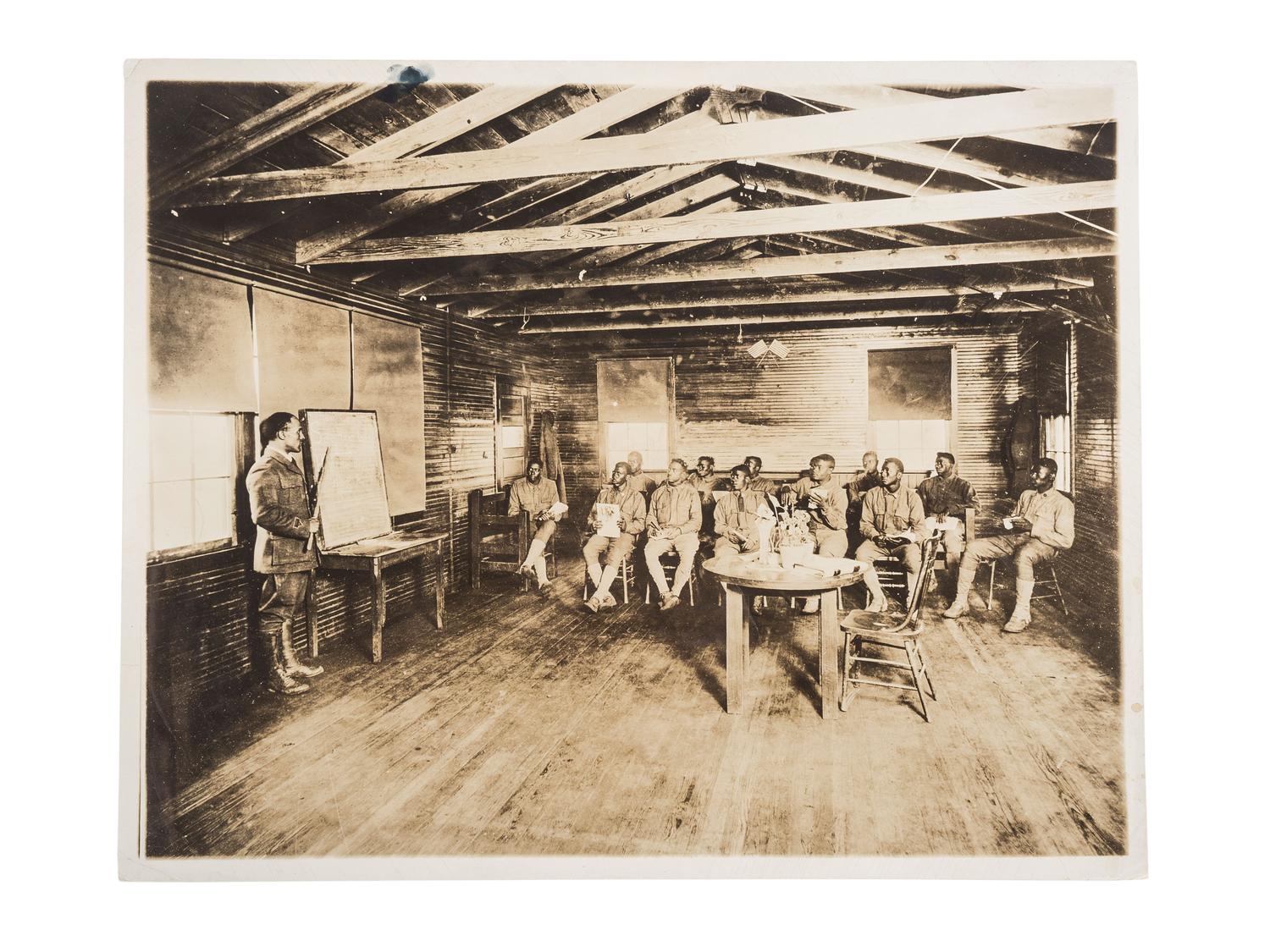 [EDUCATION]. Press photograph of African American soldiers from the 165th Depot Brigade learning to read at Camp Travis, San Antonio, TX. Boston, MA: Publicity Bureau, National War Work Council, YMCA, 24 September 1918.
